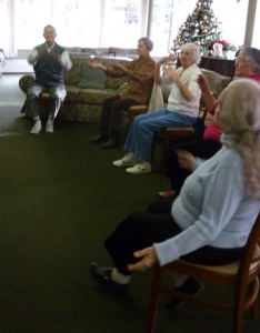 Photo of 5 people seated moving their arms