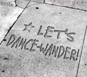 Image of pavement with "Let's Dance-Wander" written on it
